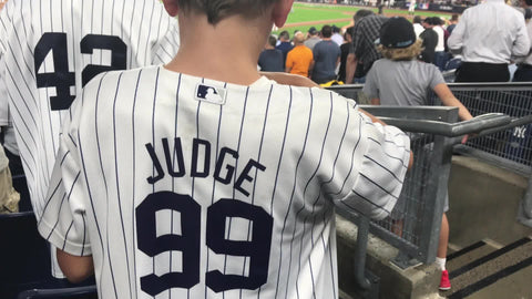 kid wearing Aaron Judge 99 jersey eating candy with father in Yankee S – NY  Clips
