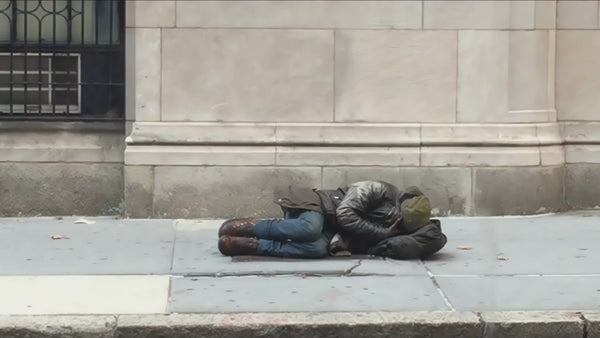 homeless man curled up cold on the street sleeping on sidewalk – NY Clips